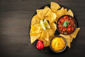 mexican nachos tortilla chips with salsa and cheese dip